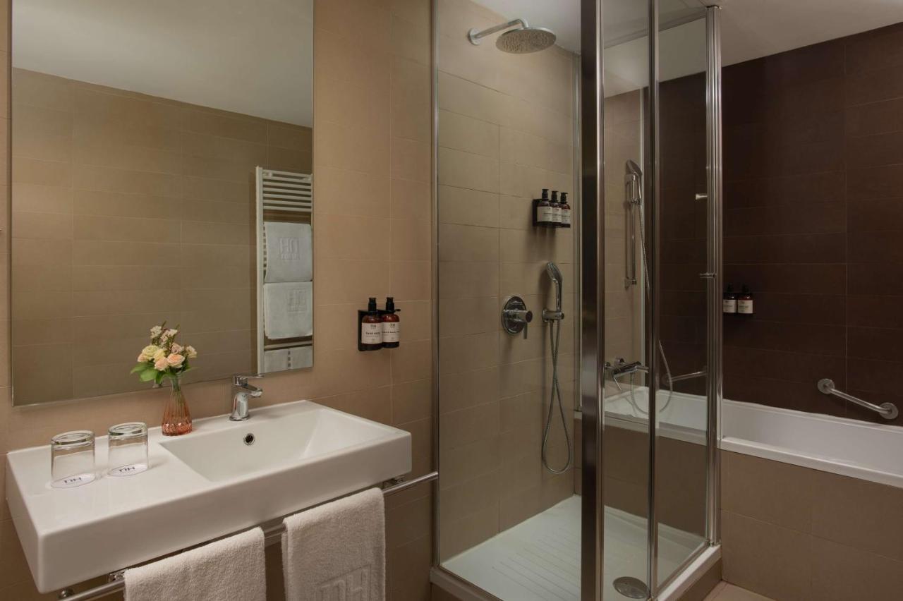 een badkamer met een wastafel en een douche bij NH Savona Darsena in Savona