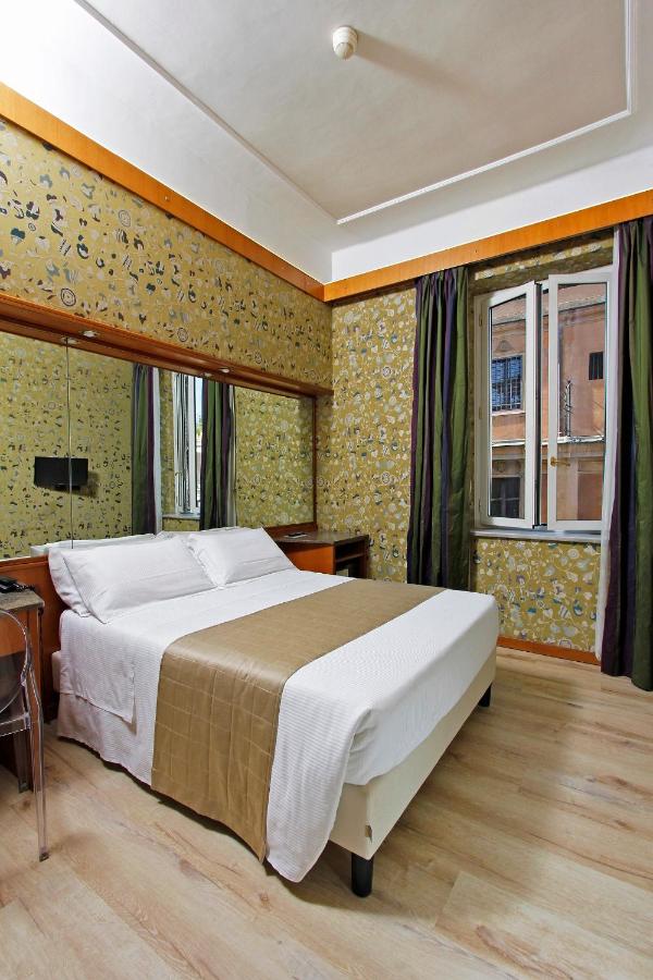 een slaapkamer met een groot bed en een raam bij Hotel Arcangelo in Rome