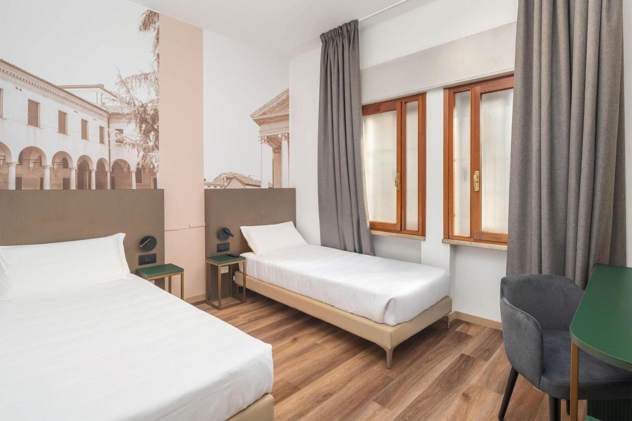 een hotelkamer met twee bedden en een raam bij B&B HOTEL Treviso Al Fogher in Treviso