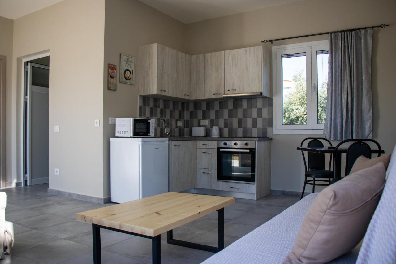 een keuken met een tafel en een keuken met een fornuis bij Casa De Rosa Apartments & Studios in Svoronata