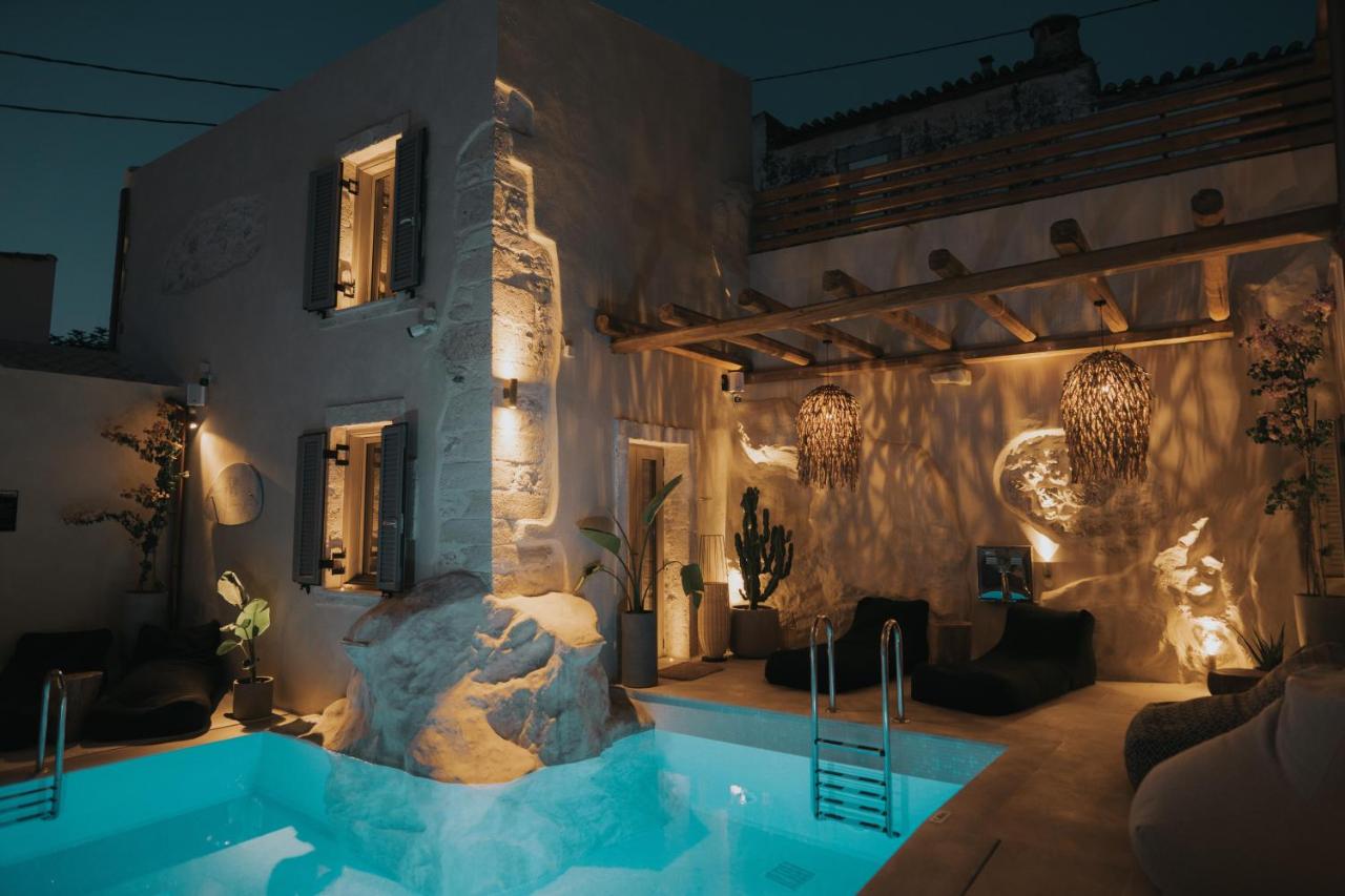 een villa met een zwembad 's nachts bij Manili Boutique Suites & Villas, an SLH Hotel in Archanes