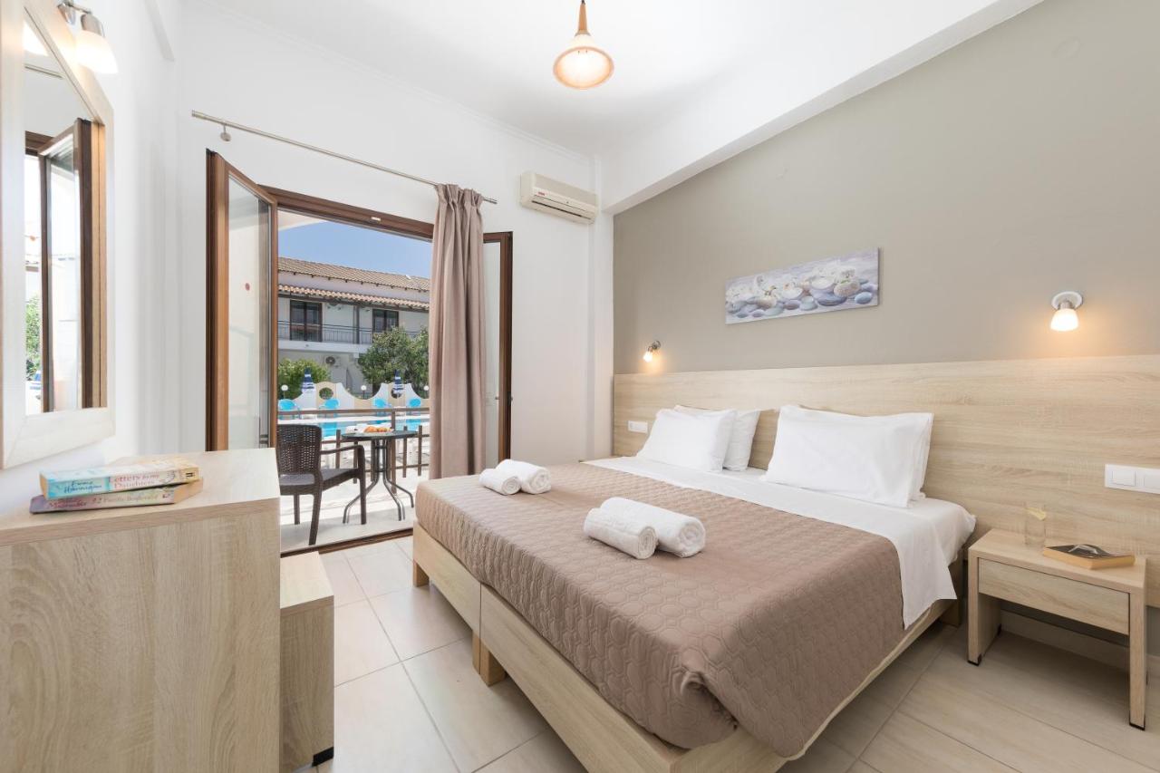 een hotelkamer met een bed en een balkon bij Lefkimi Hotel in Kavos