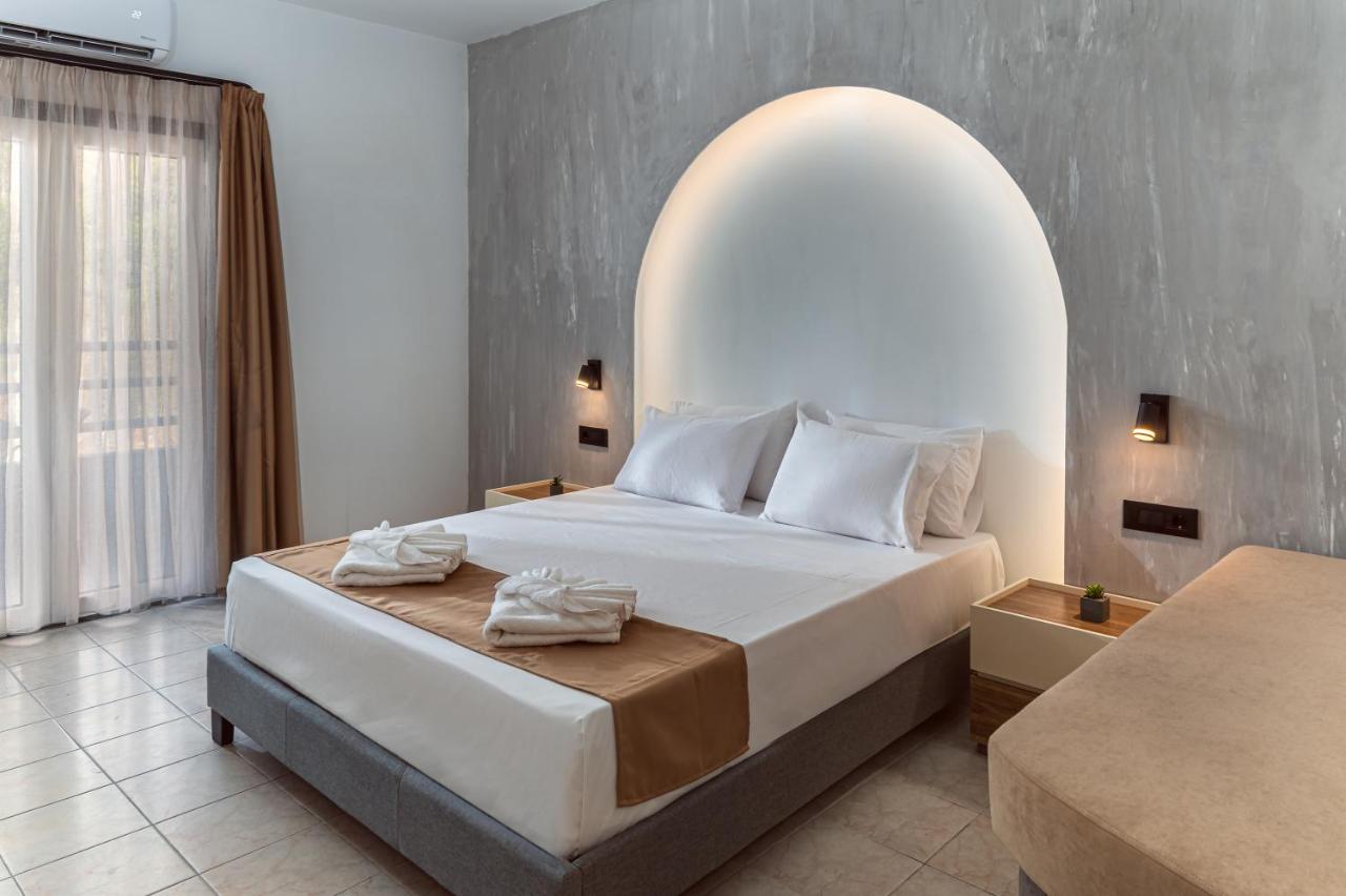 een slaapkamer met een groot bed met een boog erboven bij Sunny Hill by Estia Adults Only in Stalida