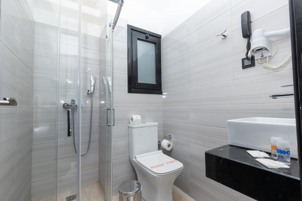 een badkamer met een douche, een toilet en een wastafel bij Evita Asty in Athene