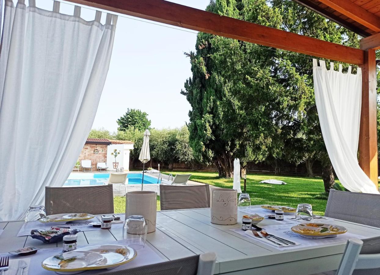een witte tafel met borden vol eten erop bij Il Giardino dei Pini in Paestum