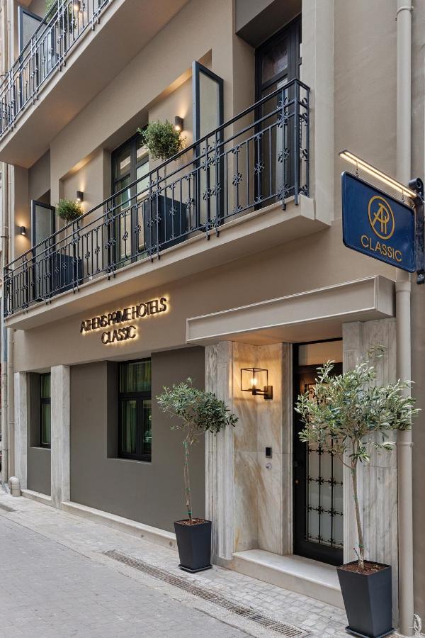 een gebouw met twee potplanten ervoor bij Classic Hotel by Athens Prime Hotels in Athene