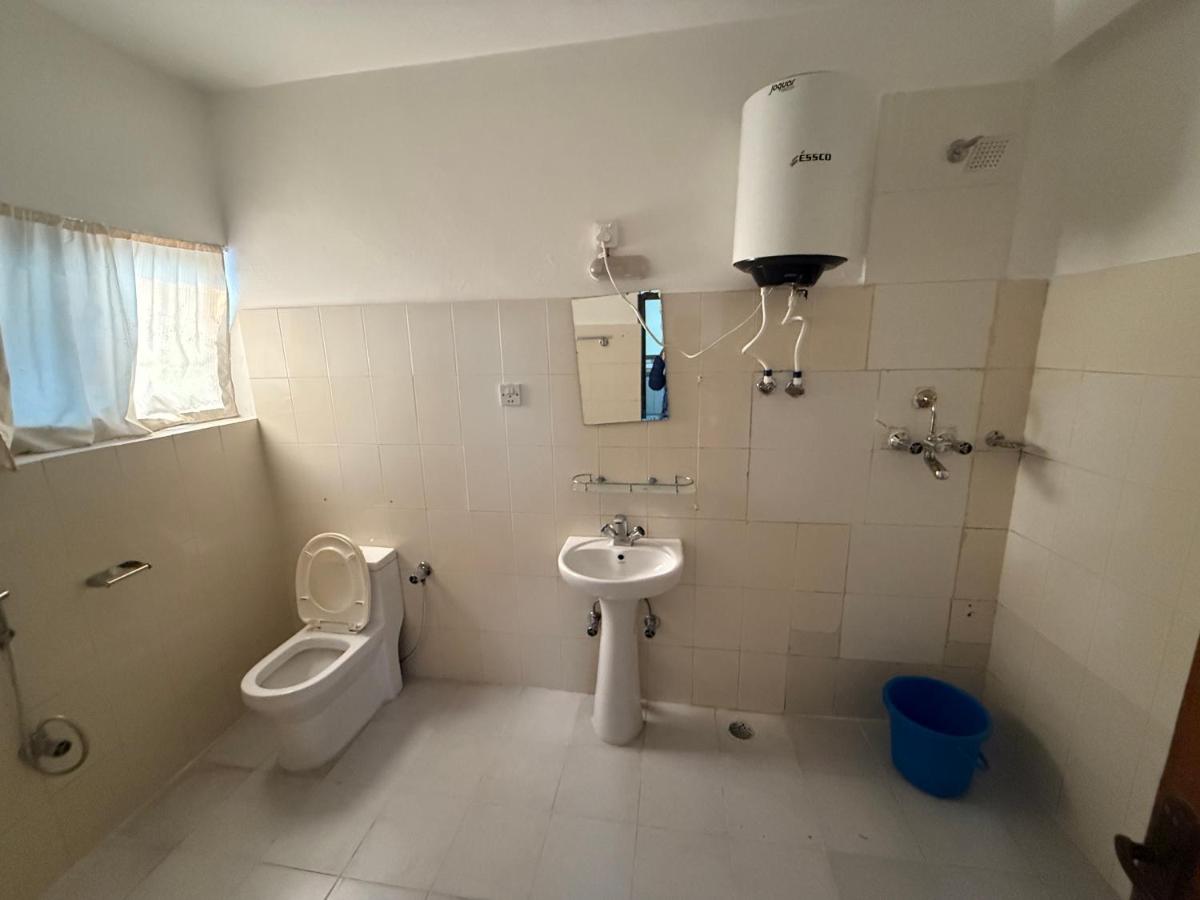 een badkamer met een toilet, een wastafel en een urinoir bij Hotel Center Inn Lake in Pokhara