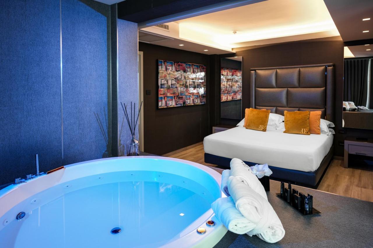 een badkamer met een groot bad naast een bed bij Hotel & Resort Tre Fontane Luxury in Portici