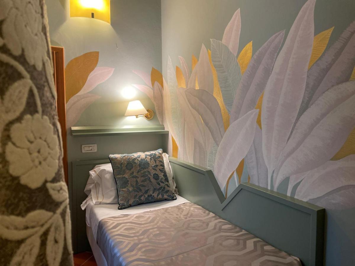 een slaapkamer met een bed waarop een kussen ligt bij Hotel Maxim Axial in Florence