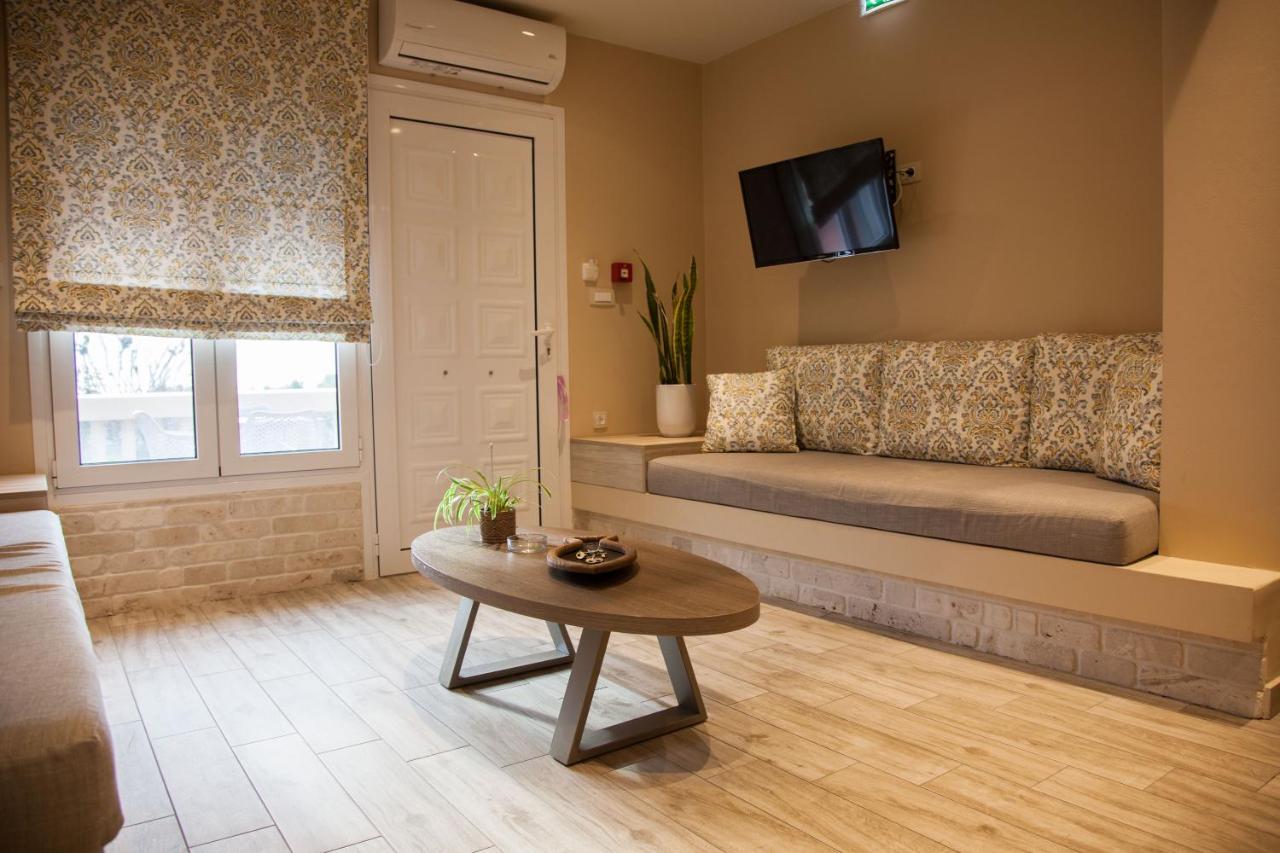 een woonkamer met een bank en een tafel bij Paporas Apartments in Svoronata
