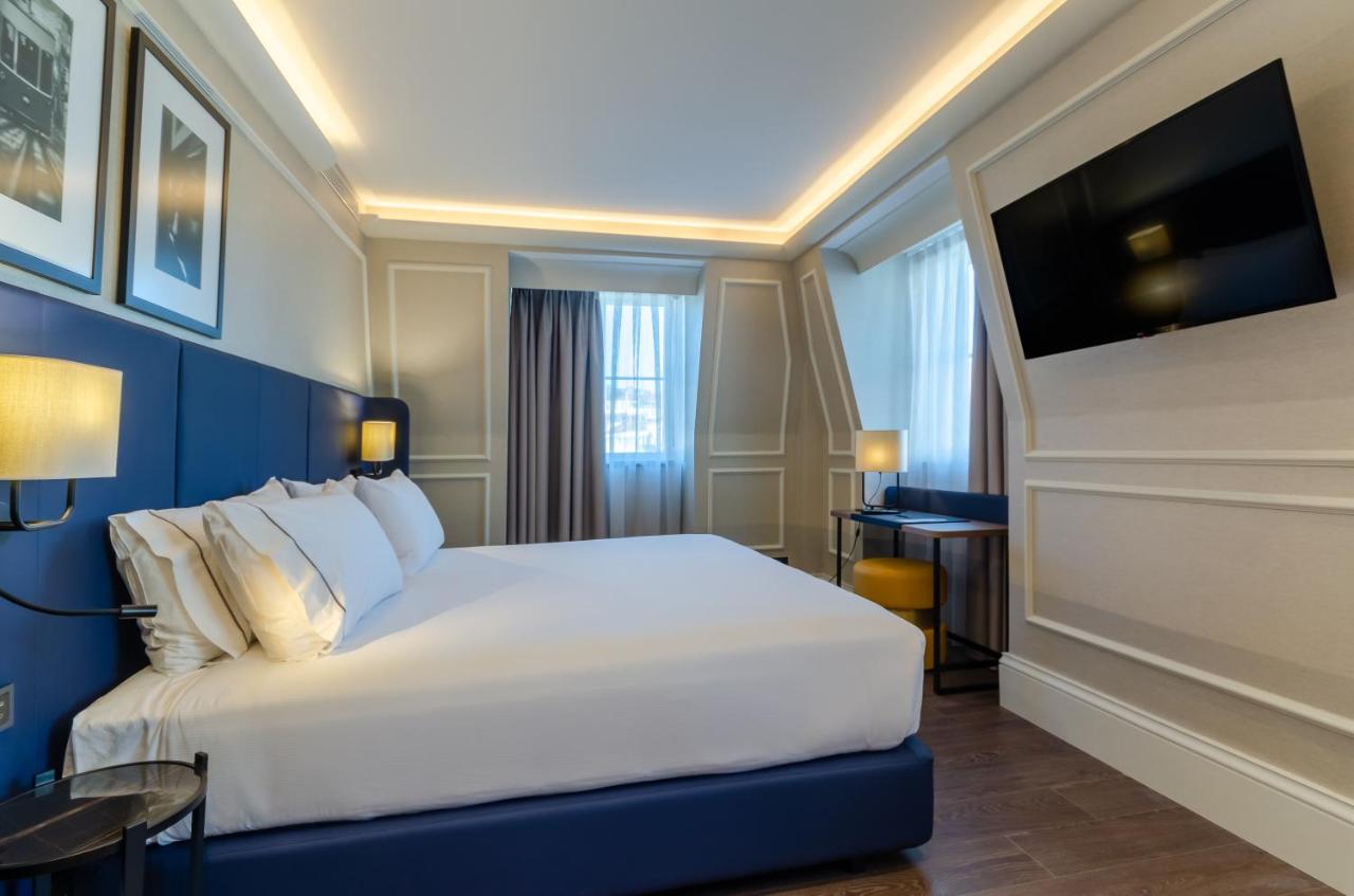 een hotelkamer met een bed en een tv bij Eurostars Lisboa Baixa in Lissabon