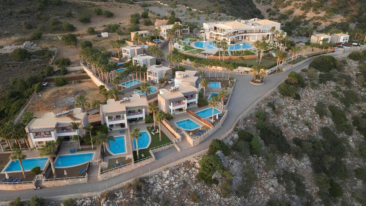 Een luchtfoto van een villa met een zwembad. bij The Noverian Scenic Crete 5 Star Hilltop Villa Resort & Spa in Malia
