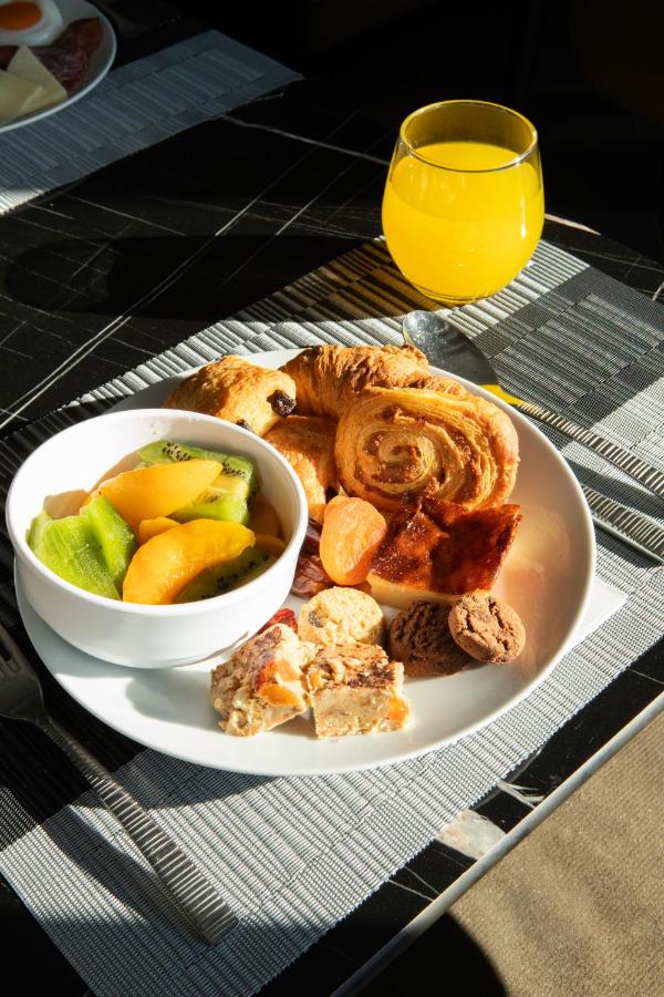 een bord met eten, met een kom brood en fruit bij Luwian Athens Boutique Hotel in Athene