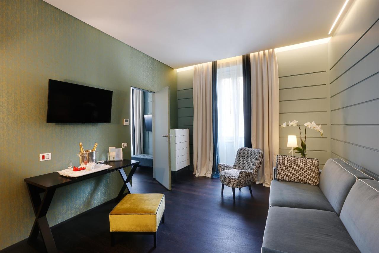 een woonkamer met een bank en een tafel bij Stendhal Luxury Suites in Rome