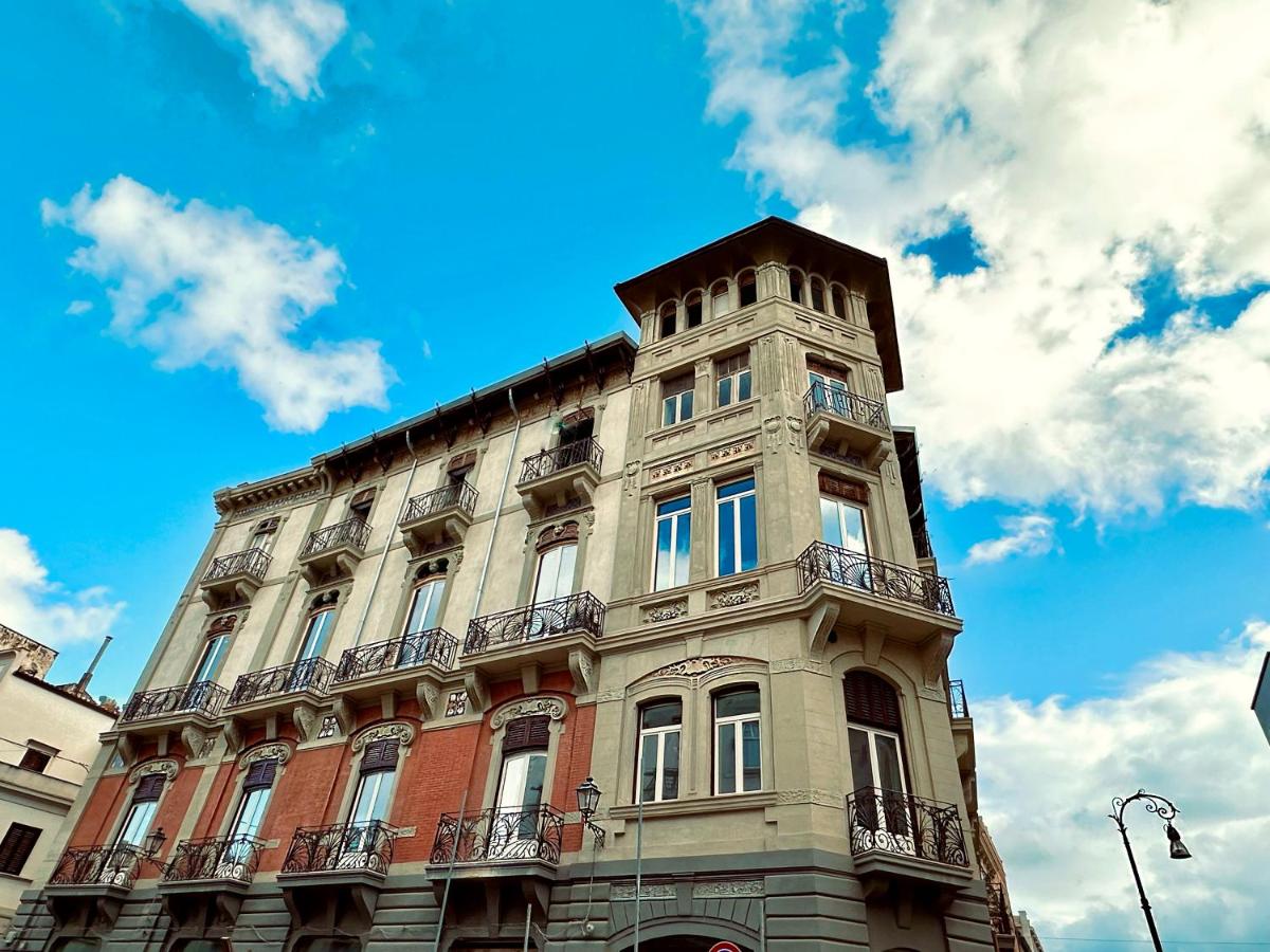 een hoog gebouw met een klokkentoren bovenop bij Palazzo Liberty Unique Hotel by Geocharme in Palermo
