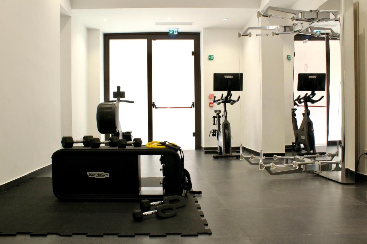 een sportschool met loopbanden en apparaten in een ruimte bij Palazzo Cartari in Palermo