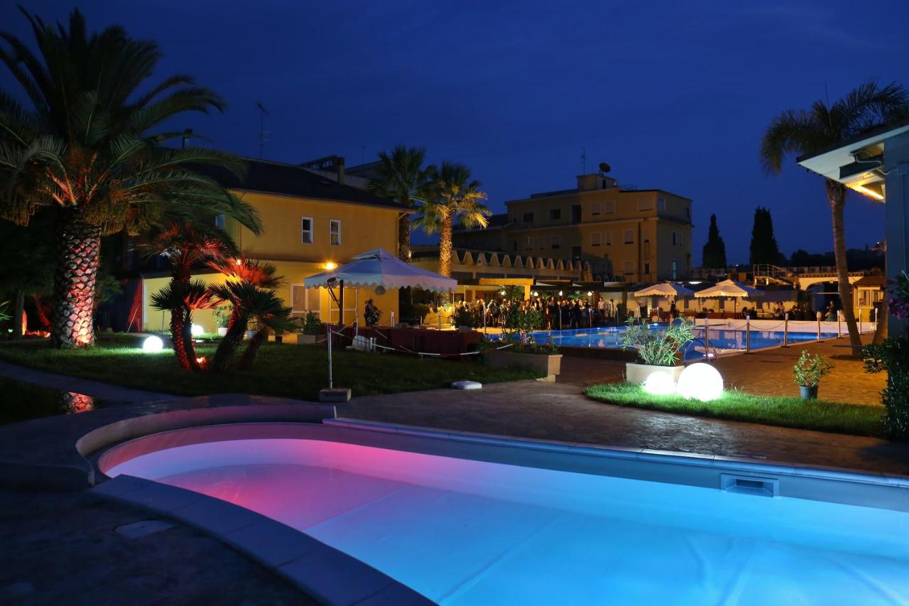 een zwembad in een resort 's nachts bij Park Hotel Paradiso in Piazza Armerina