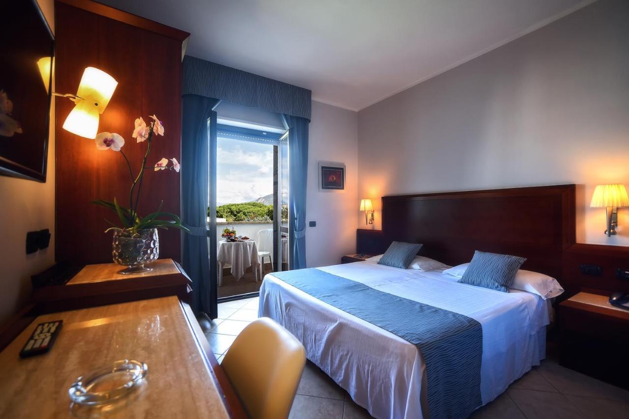 een hotelkamer met een bed, een tafel en een raam bij Hotel Le Palme in Paestum