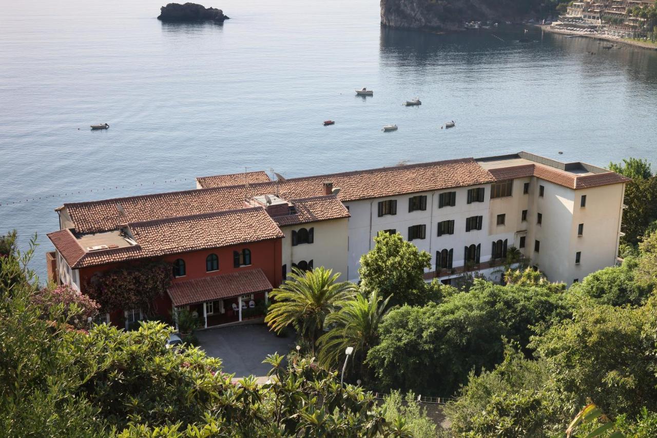 een gebouw aan het water met boten erin bij Hotel Lido Mediterranee in Taormina