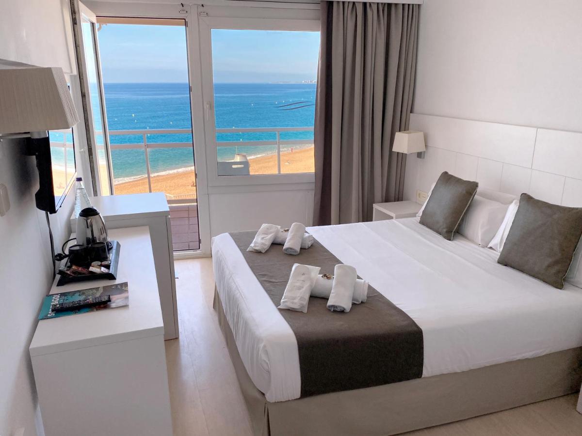 een slaapkamer met een bed en uitzicht op de oceaan bij Hotel Rosamar Maxim 4*- Adults Only in Lloret de Mar