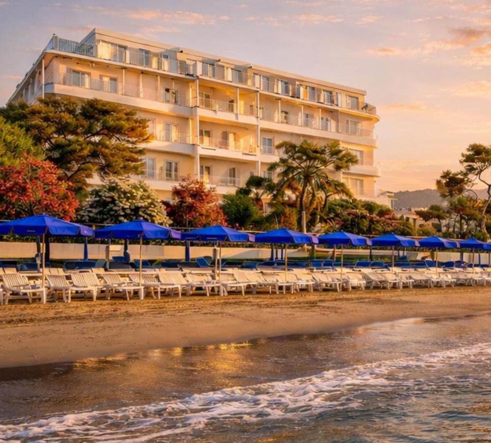 een hotel aan het strand met stoelen en parasols bij LVG Hotel Collection - Grand Hotel Mediterranee in Alassio