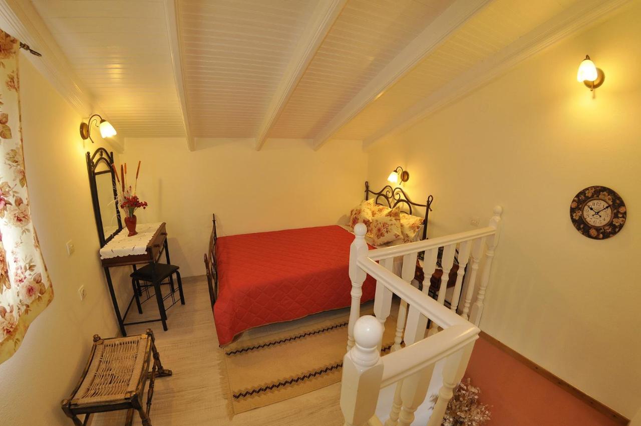 een slaapkamer met een rood bed en een trap bij Mazis Apartments in Agios Gordios +107 foto's