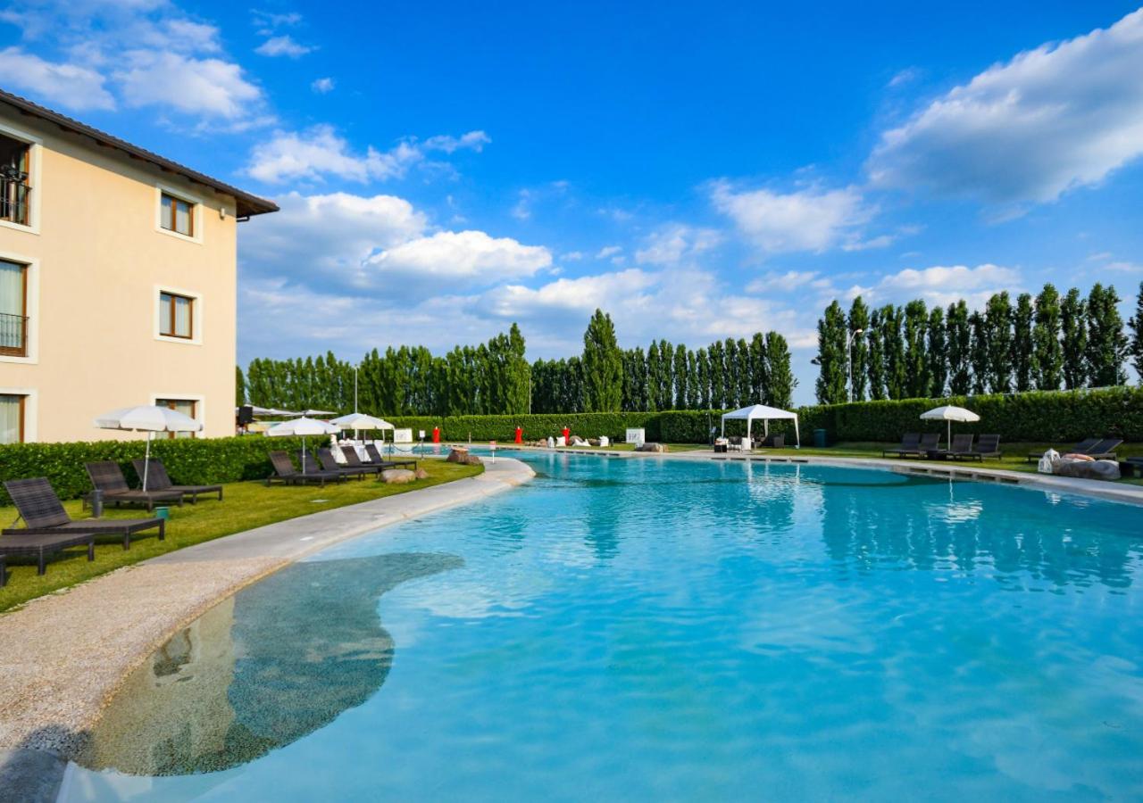 een groot zwembad voor een gebouw bij TH Lazise - Hotel Parchi Del Garda in Lazise