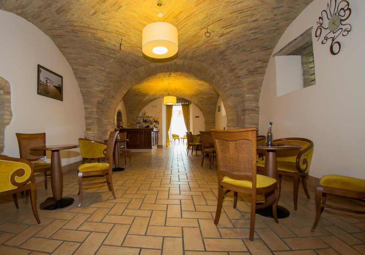 een eetzaal met tafels en stoelen in een gebouw bij Il Parco Sul Mare Resort & SPA in Tortoreto Lido