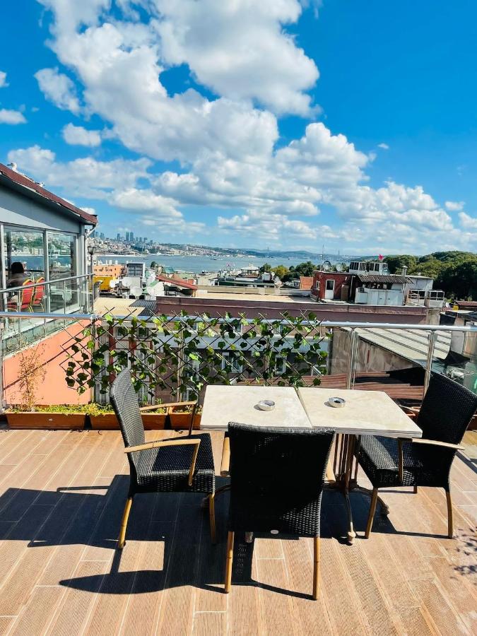 een terras met een tafel en stoelen op een dak bij Sirkeci Park Hotel in Istanbul