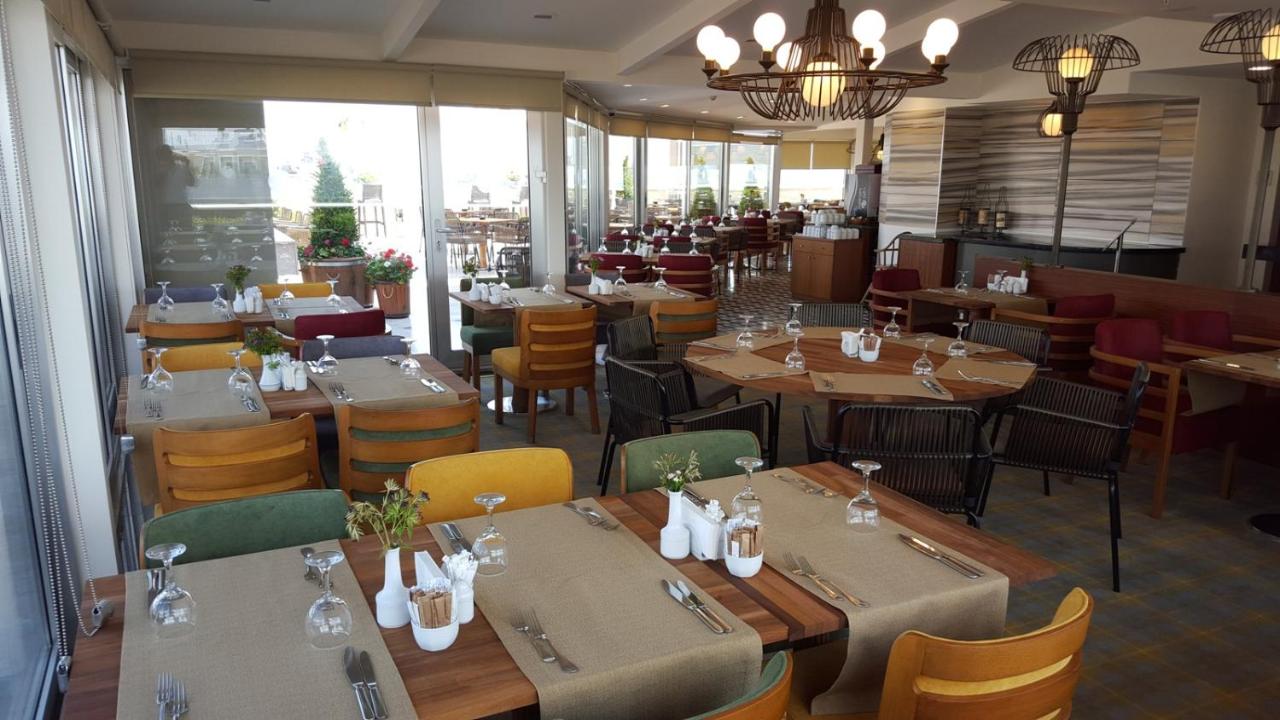 een eetzaal met tafels en stoelen en een restaurant bij Taksim Gonen Hotel in Istanbul