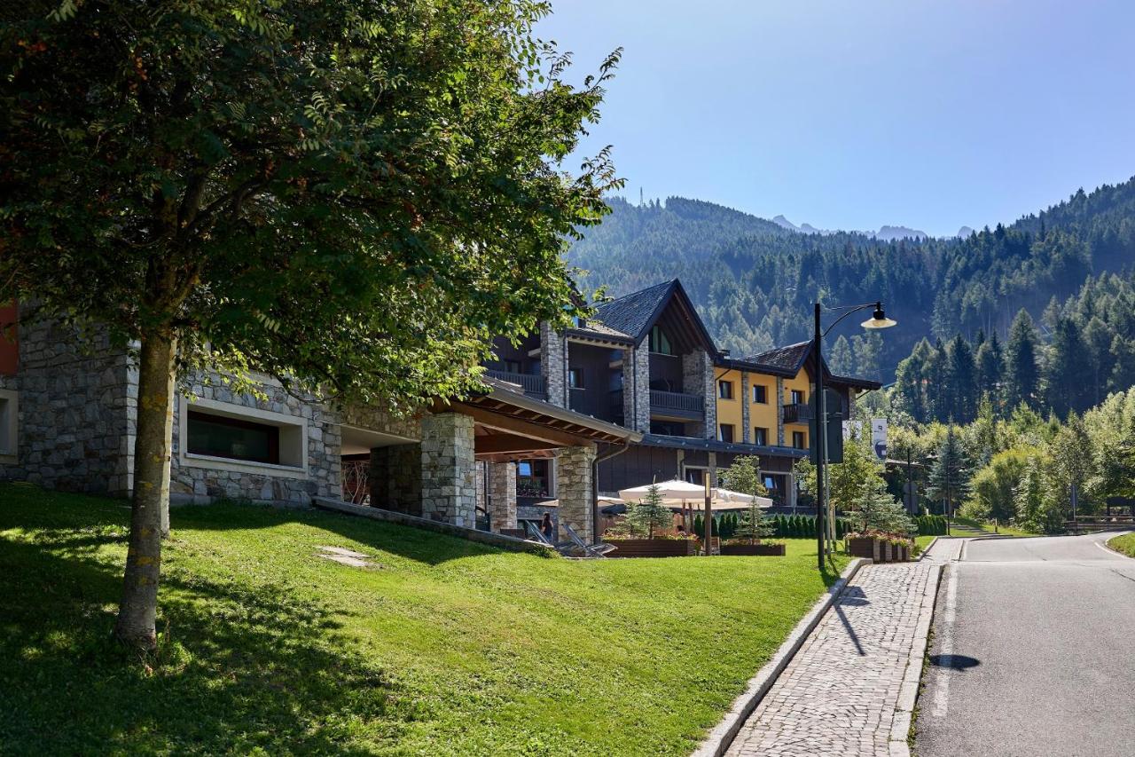 een groot huis aan de kant van de weg bij Blu Hotel Acquaseria in Ponte di Legno