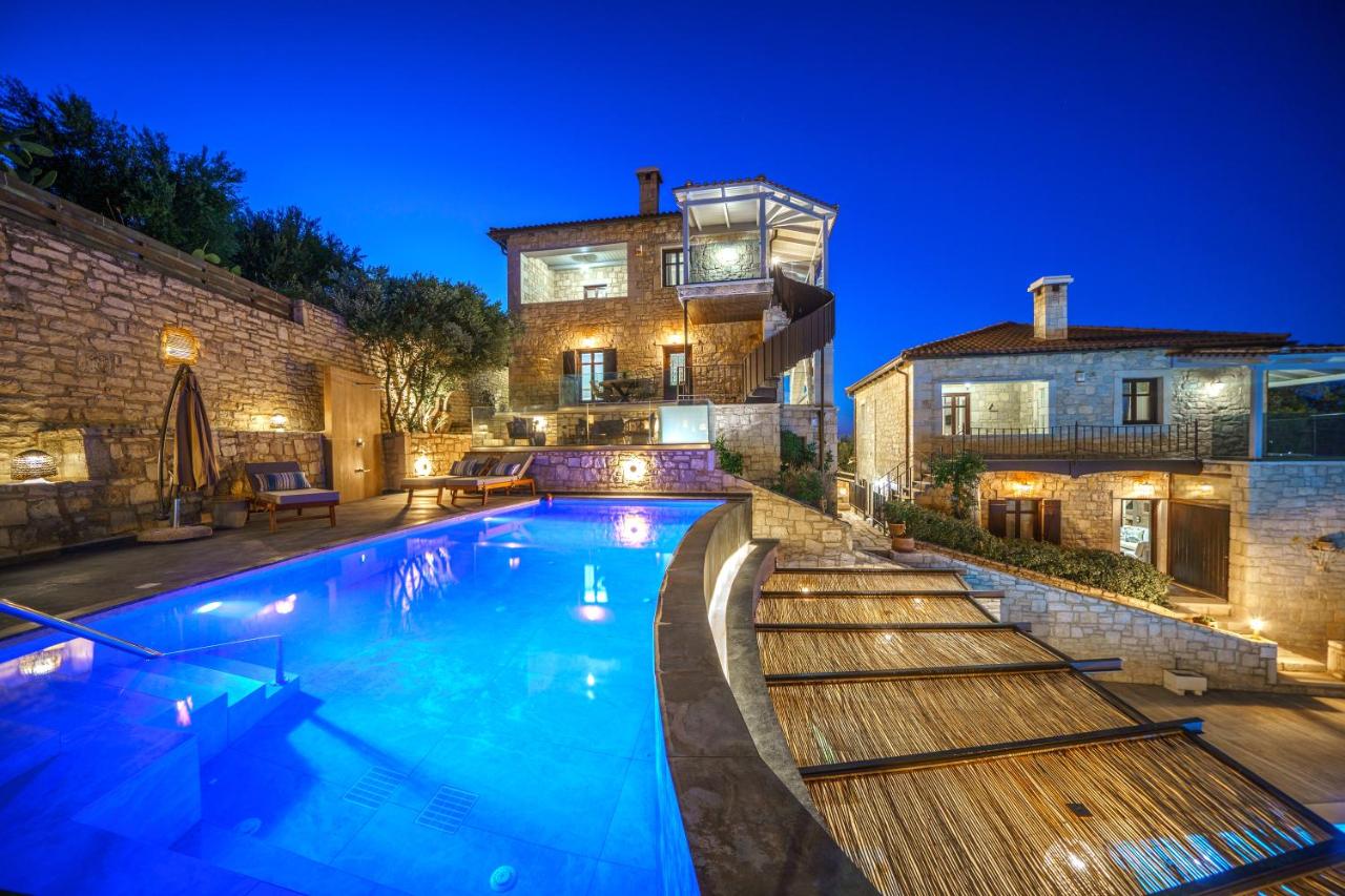 een zwembad voor een huis 's nachts bij Asion Lithos Villas & Suites with Private Pools in Kato Asites