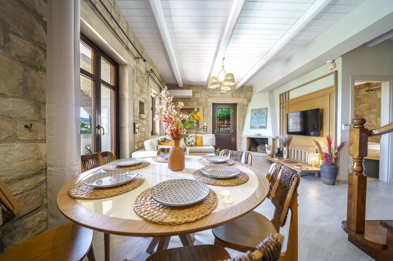 een grote eetkamer met een tafel en stoelen bij Asion Lithos Villas & Suites with Private Pools in Kato Asites