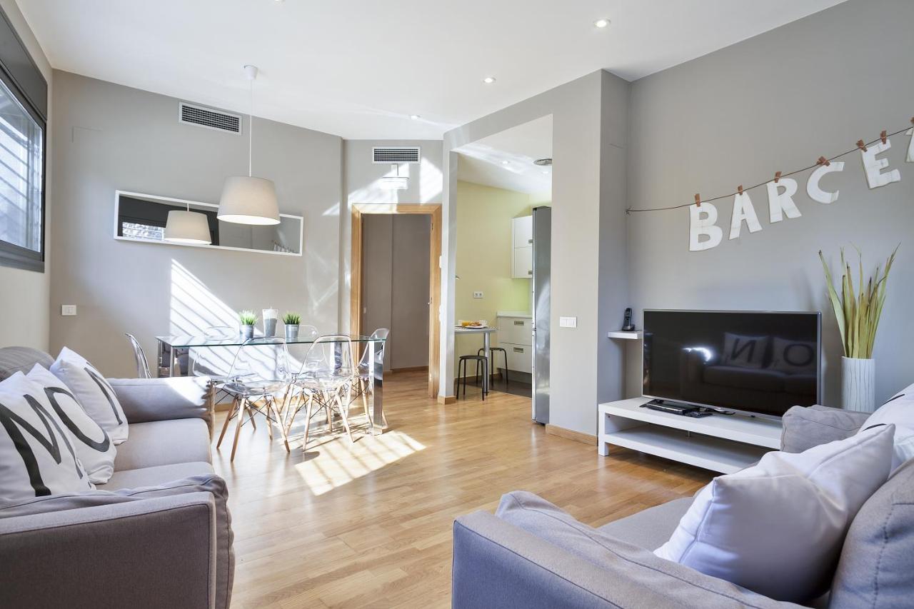 een woonkamer met twee banken en een tv bij Hotel Acta Laumon in Barcelona