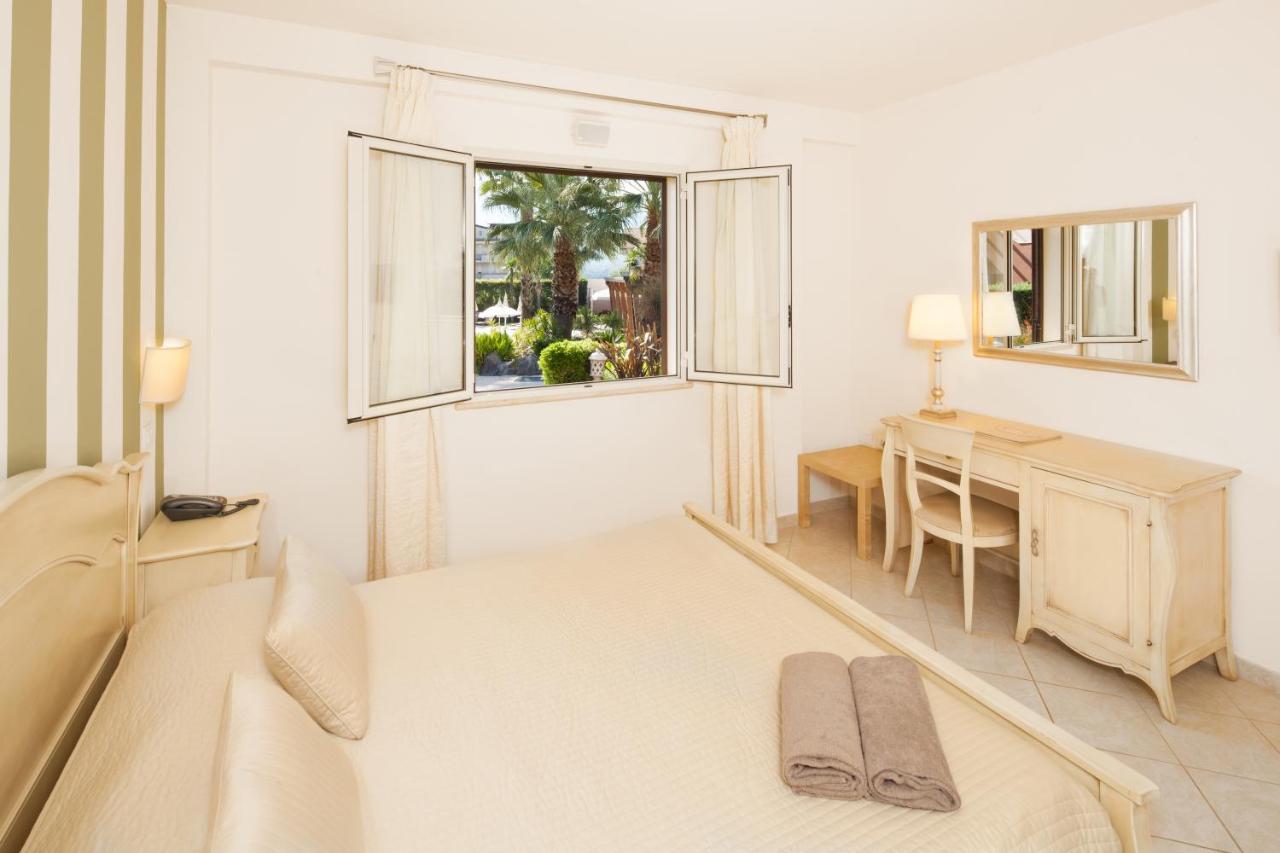 een slaapkamer met een bed, een bureau en een raam bij Alcantara Resort, Charming & Relaxing Hotel , Adults Only 16 plus