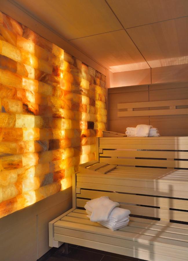 een sauna met twee ligbedden en een houten wand bij Aqualux Hotel Spa Suite & Terme in Bardolino