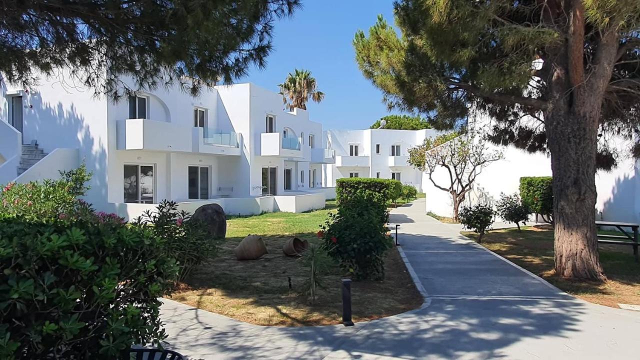 een wandelpad voor een wit gebouw bij Summer Village of Hippokrates - Adults only in Marmari