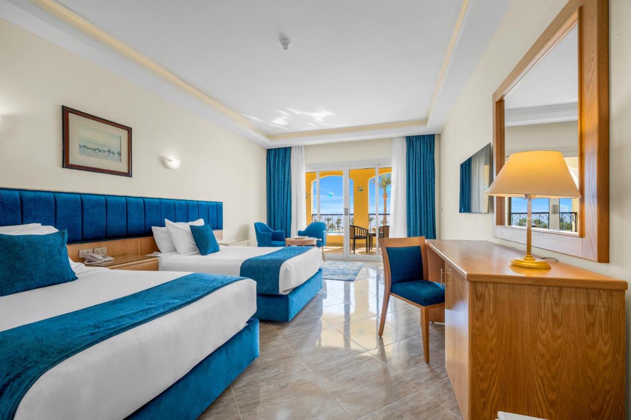 een hotelkamer met twee bedden en een bureau bij Grand Oasis Resort in Sharm El Sheikh
