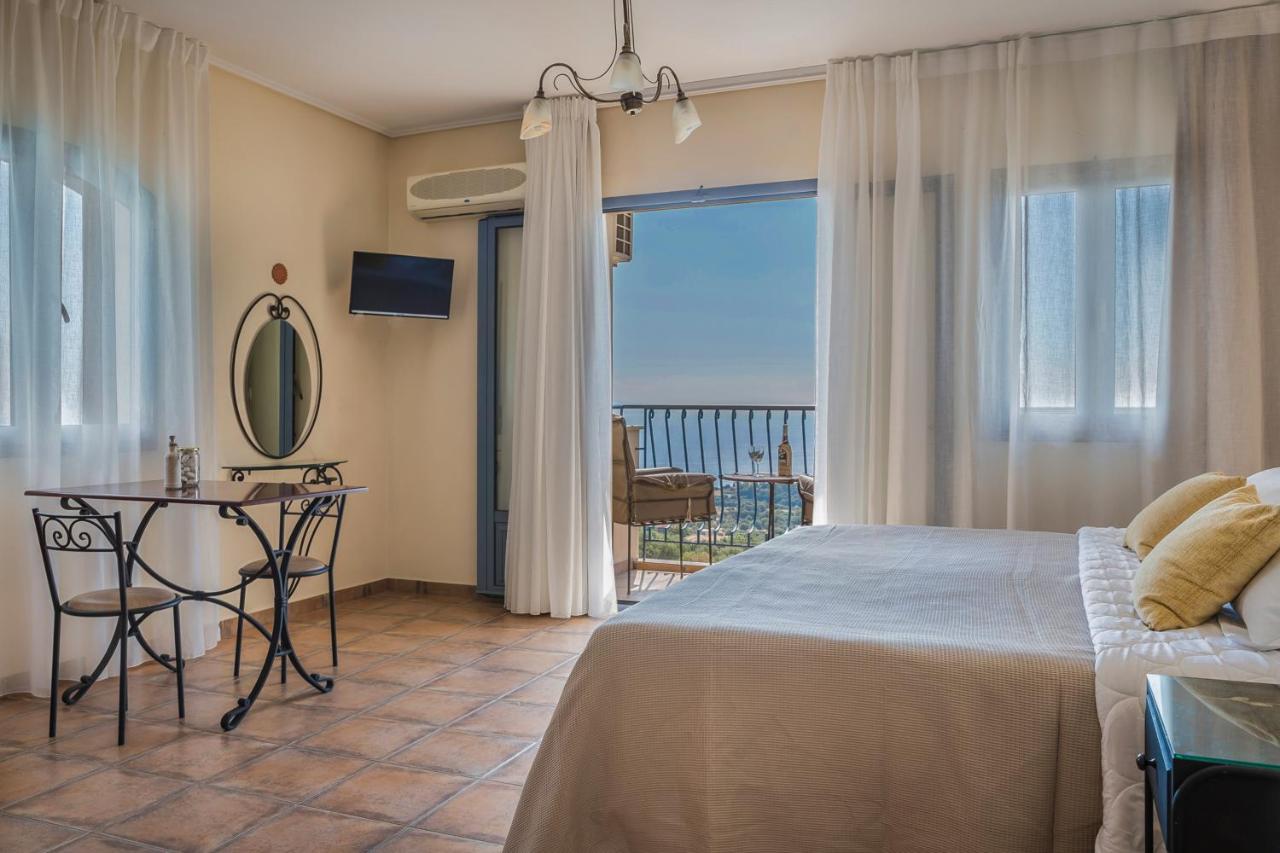 een slaapkamer met een bed, een tafel en een balkon bij Diana Studios in Trapezaki