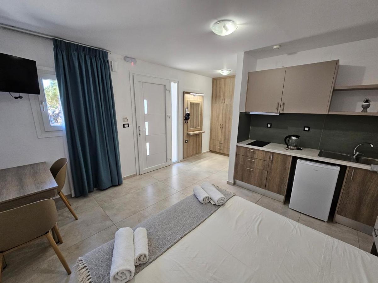 een woonkamer met een keuken en een tafel bij Elounda Sunrise Apartments in Elounda