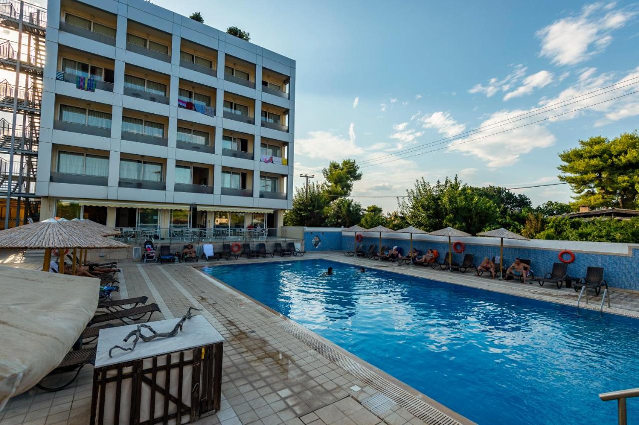 een groot zwembad voor een gebouw bij Dolphin Resort & Conference in Kalamos