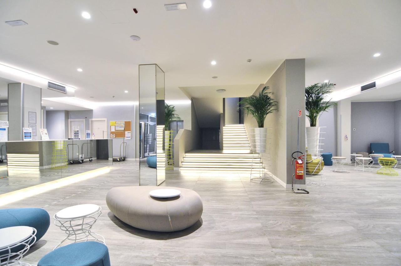 een lobby met een tafel en stoelen in een gebouw bij Marina Palace Hotel 4 stelle S in Caorle +201 foto's