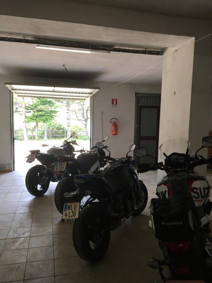 een paar motorfietsen geparkeerd in een garage bij Gorropu Hotel in Urzulei