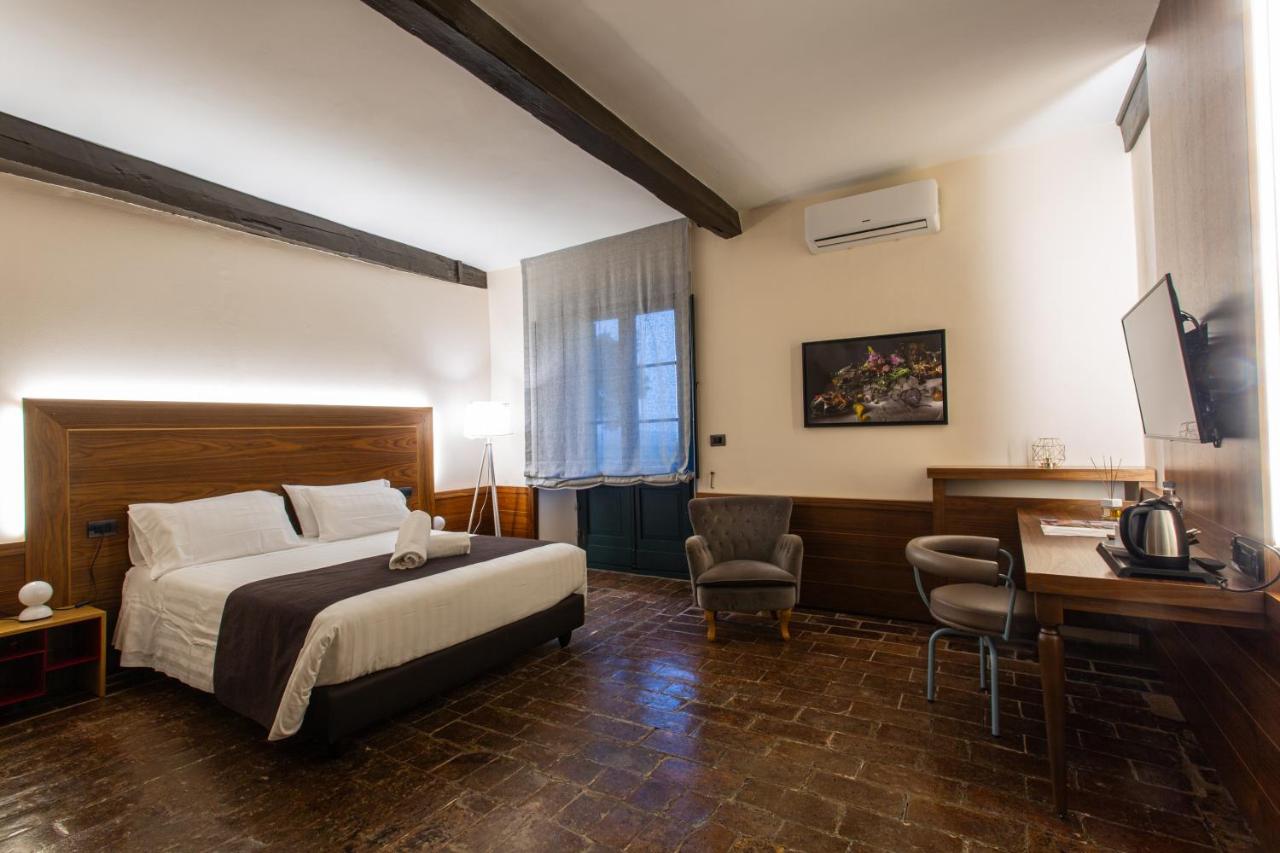 een hotelkamer met een bed en een bureau bij La Loggia Historic Resort - Albergo Diffuso in Gradara