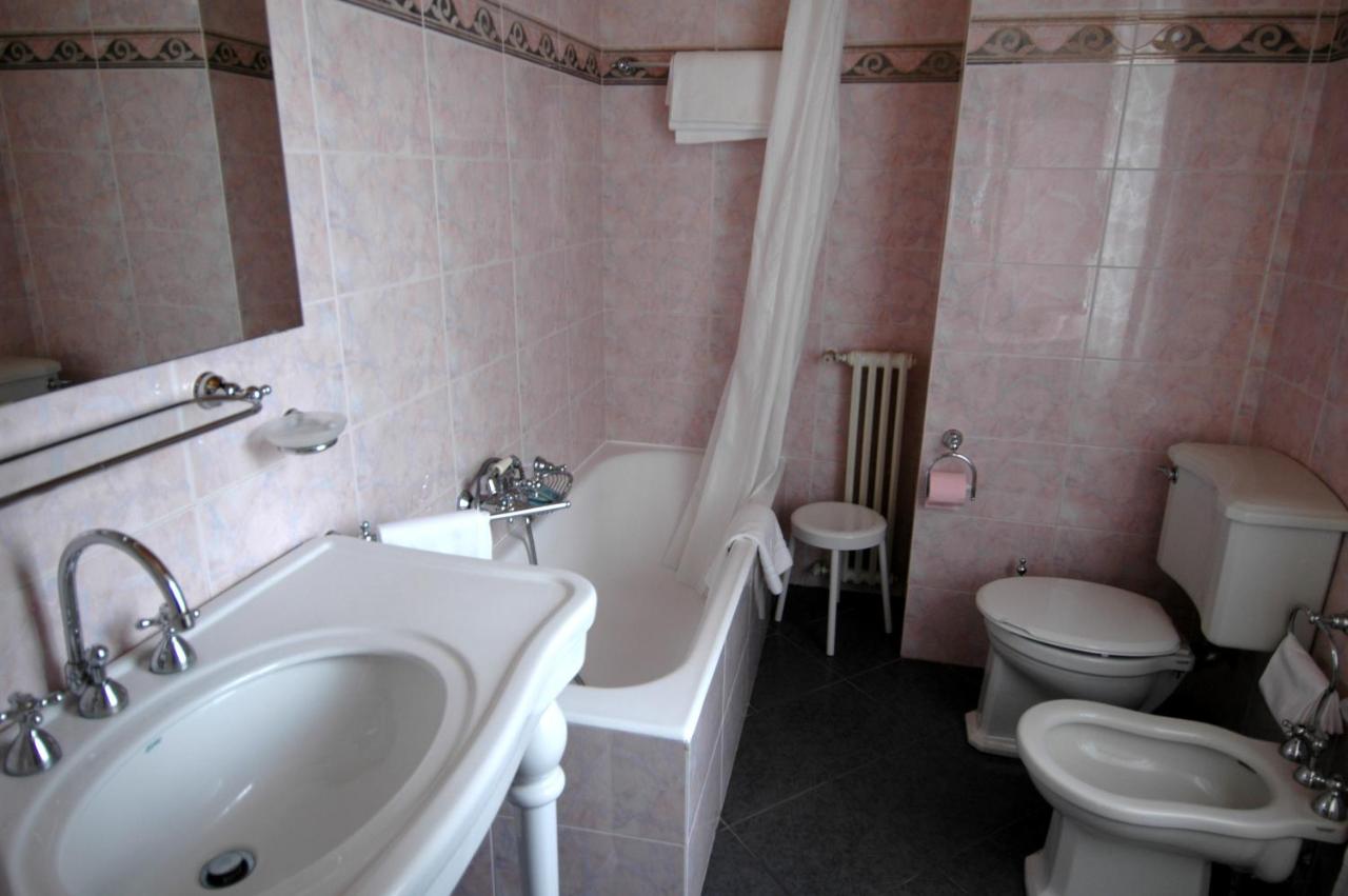 een badkamer met een badkuip, een wastafel en een toilet. bij TH San Martino - Majestic Dolomiti Hotel in San Martino di