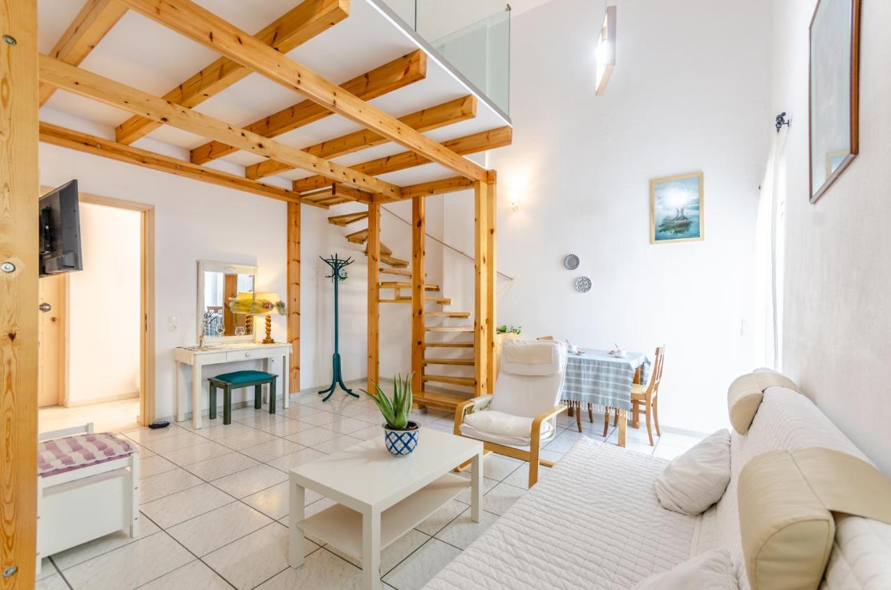 een woonkamer met een bank en een tafel bij Happiness Apartments in Chersonissos