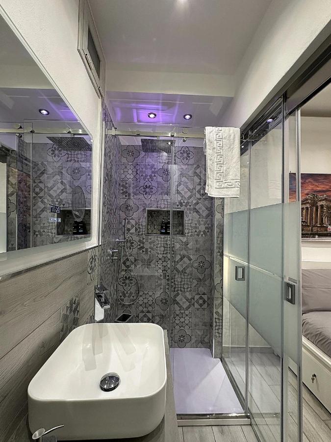 een badkamer met een glazen douche en een wastafel bij Ó sole mio in Palermo