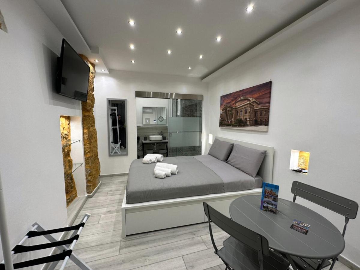 een slaapkamer met een bed, een tafel en een televisie bij Ó sole mio in Palermo