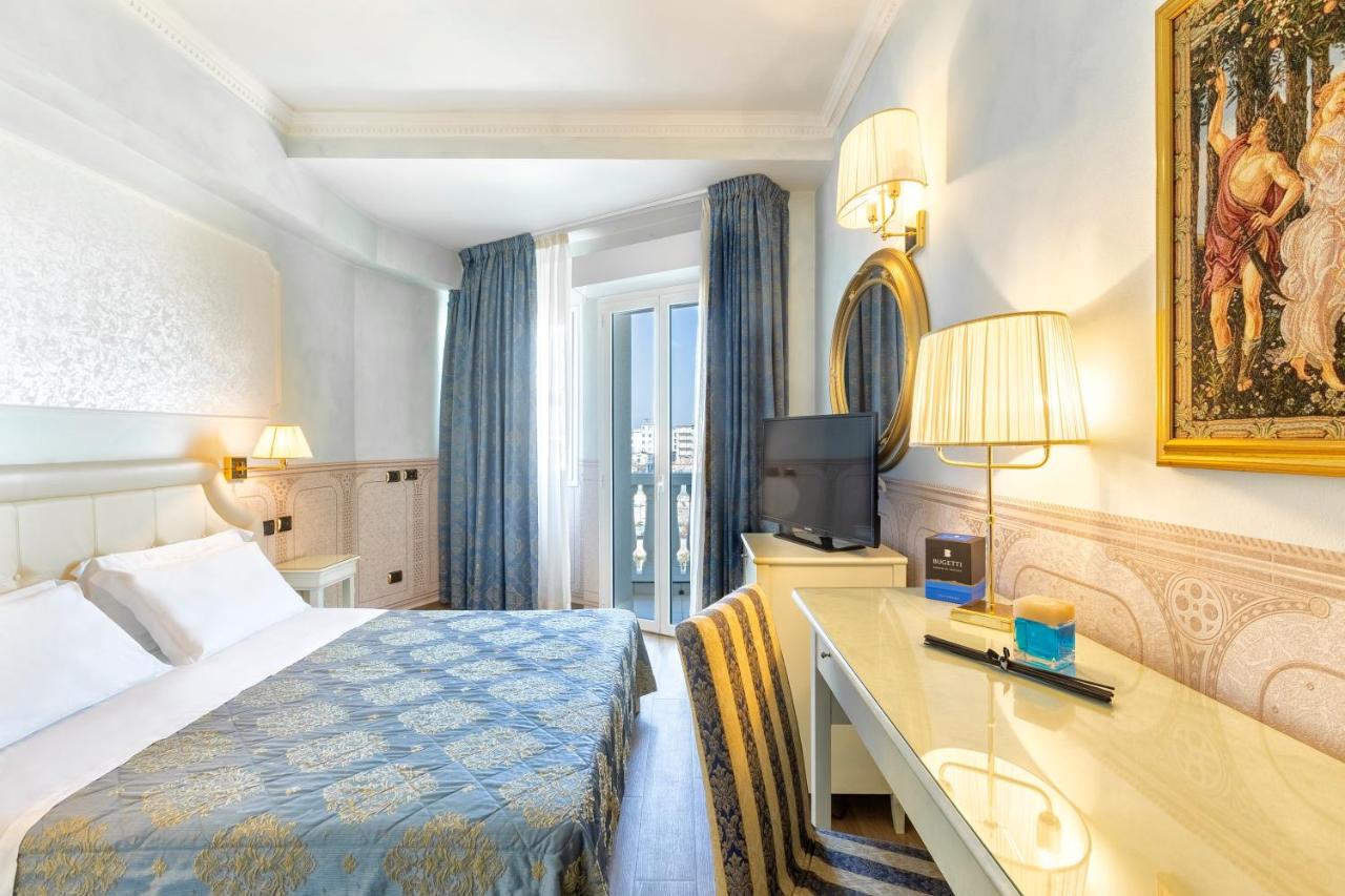 een hotelkamer met een bed en een bureau bij Hotel Baia Imperiale in Rimini +69 foto's