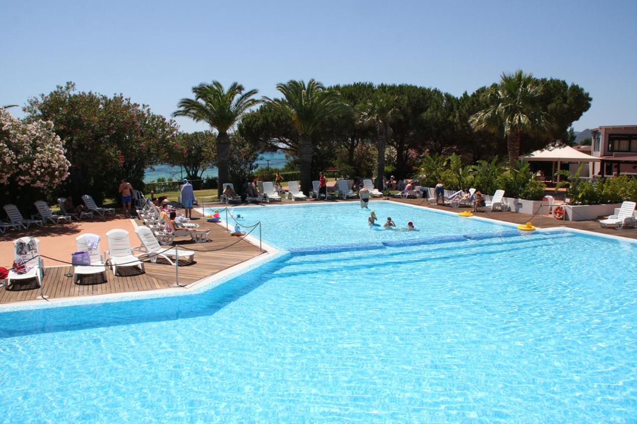 een groot zwembad met mensen in een resort bij TH Costa Rei - Free Beach Resort in Monte Nai +34 foto's